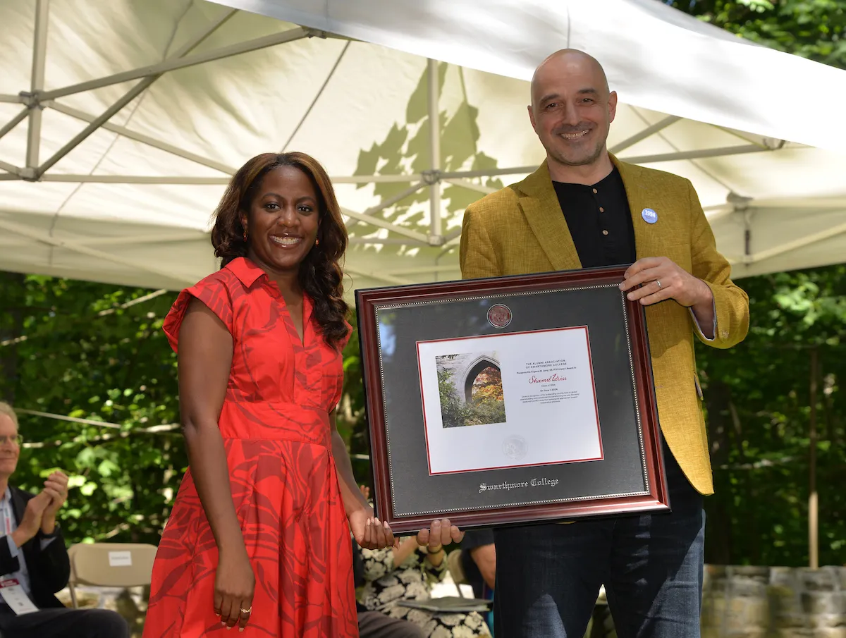 Shamil Idriss Deborah How poses with award presented by Ayanna Johnson