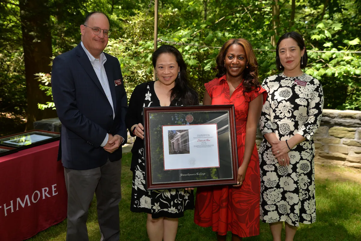 Deborah How poses with award presented by Ayanna Johnson, Rob Goldberg, and Tomoko Sakomura