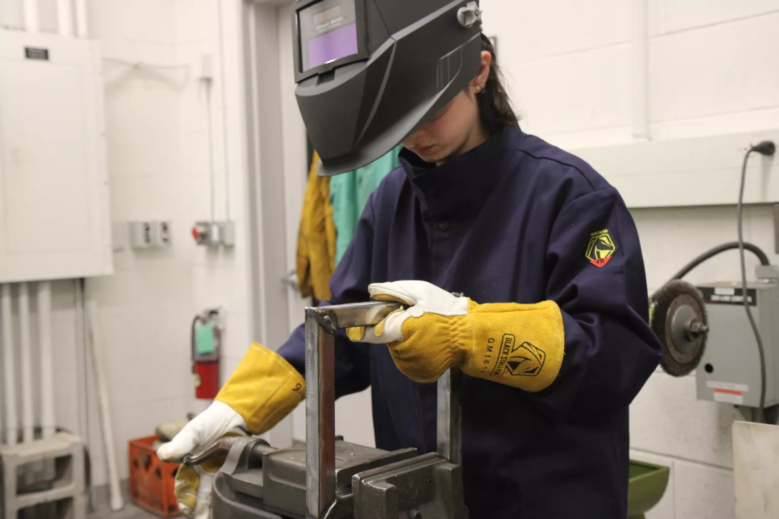 Student welding in the Sculpture II: Metal class.