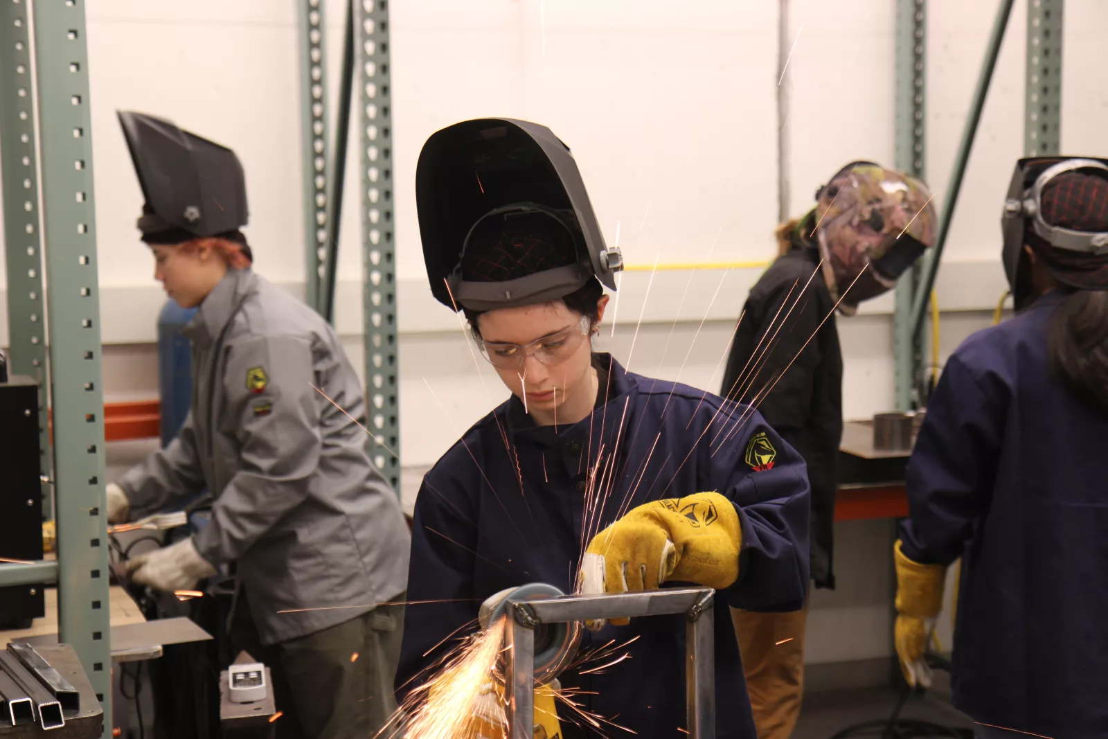 Student creating a water tight vessel in the Sculpture II: Metal class.