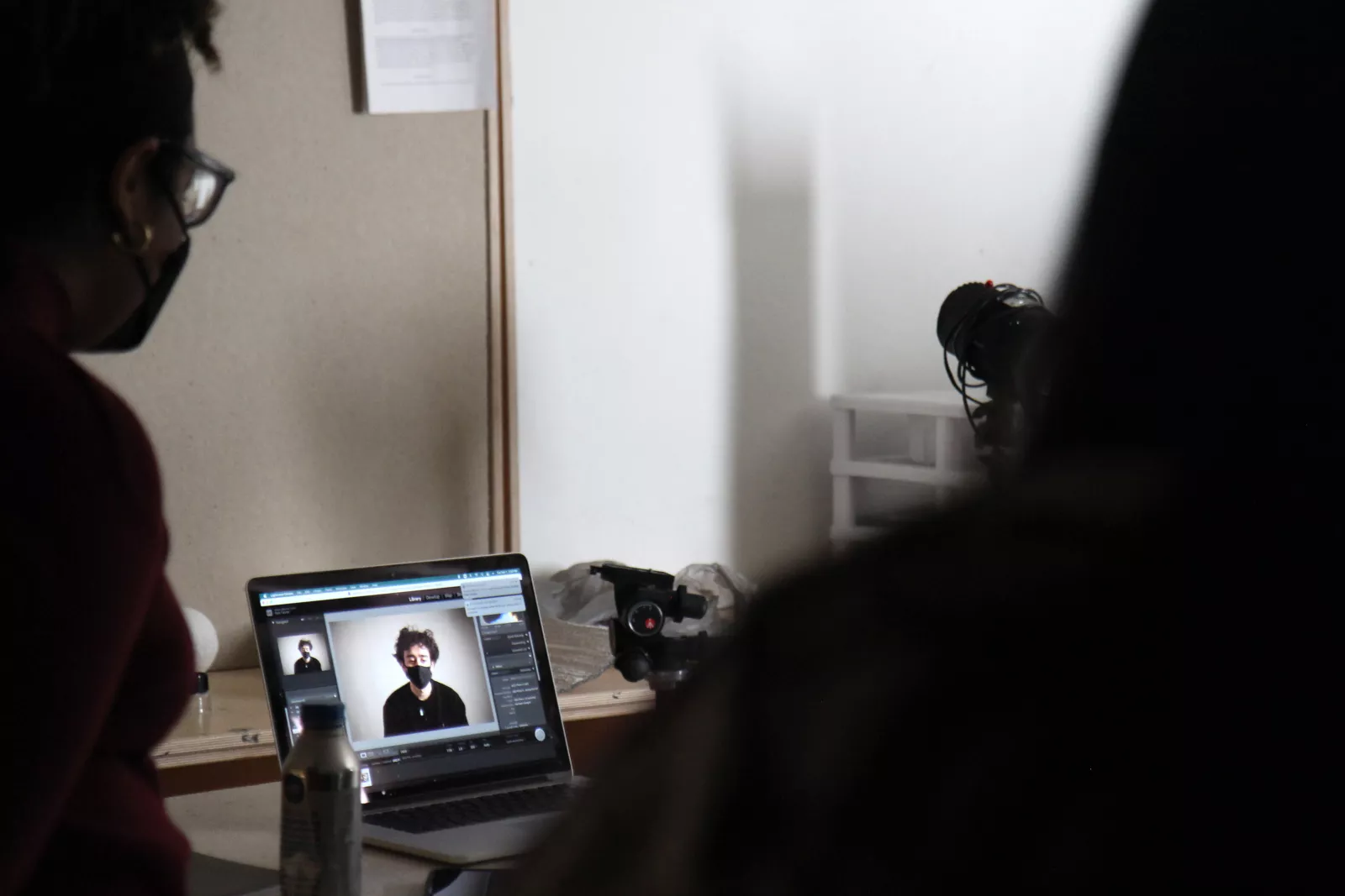 Photography portrait lab. Students observing photo still capture from digital SLR camera. Photography II: The Long Term Project.