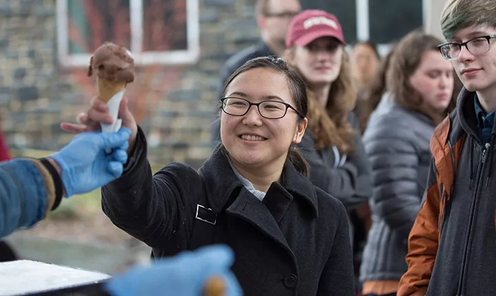 A student is handed ice cream