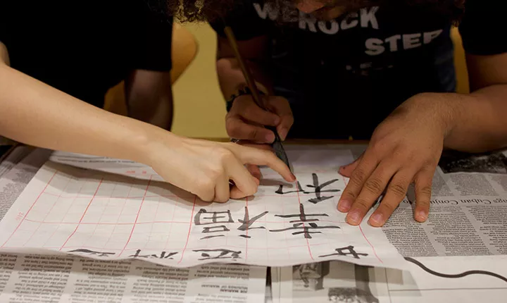 A student learns calligraphy 