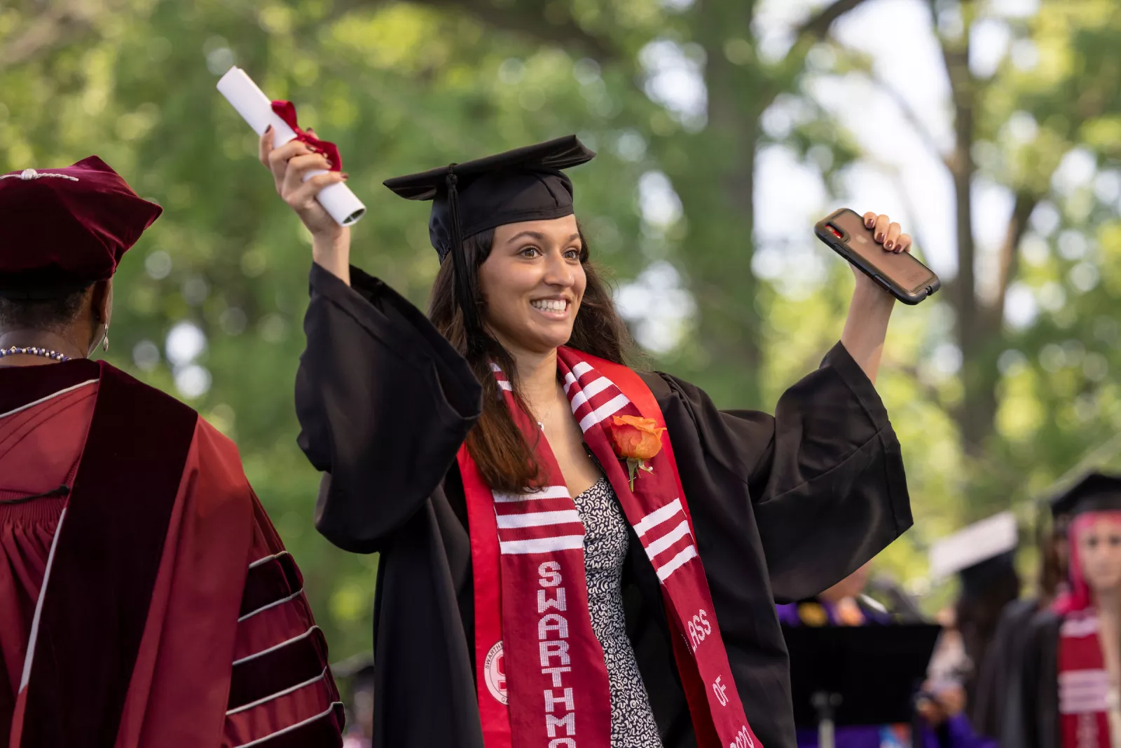 Student receives diploma and celebrates