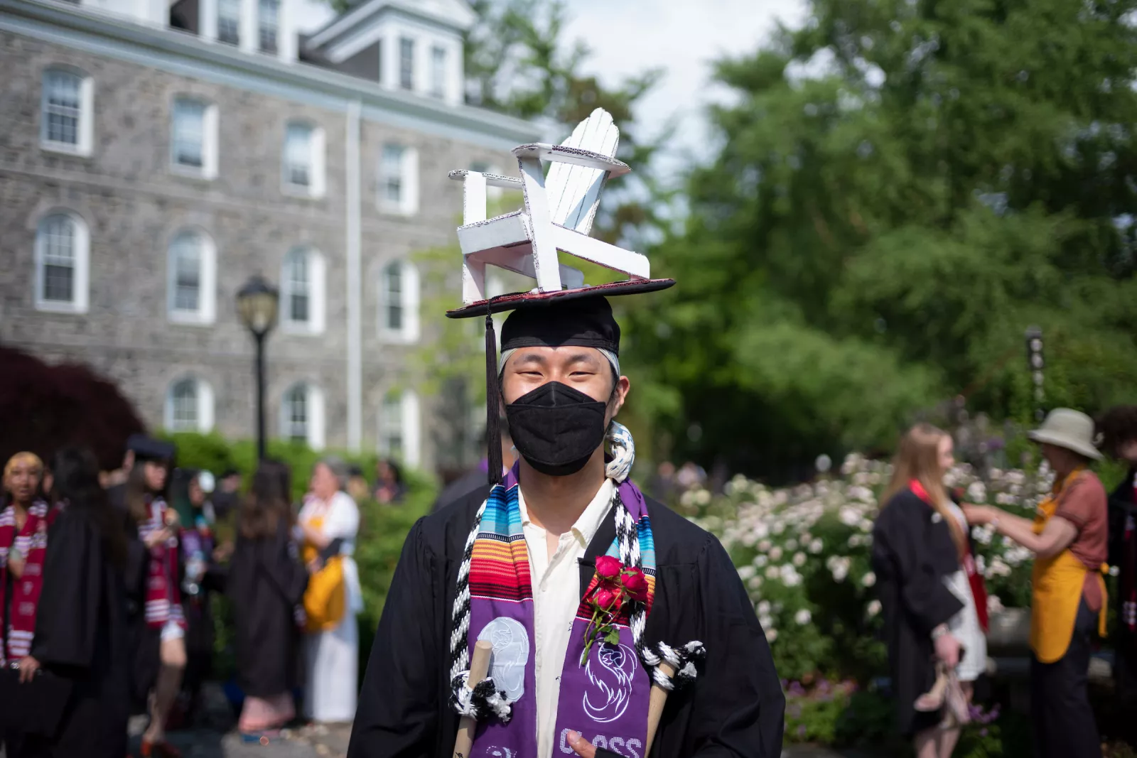 Person with graduation cap featuring Adirondack chair