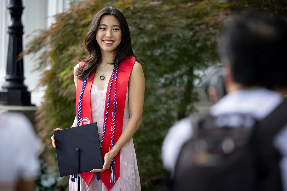 Student poses with graduation cap