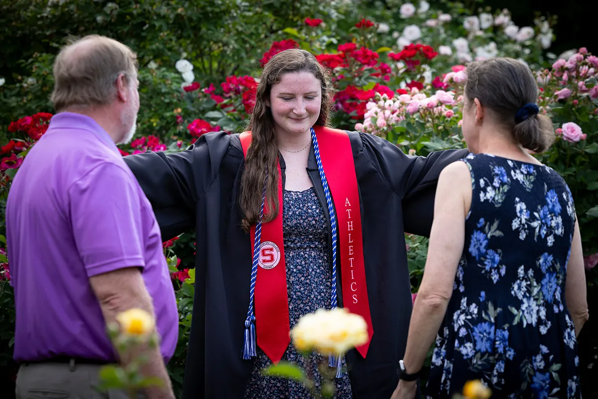 Student and parents talk after baccalaureate ceremony