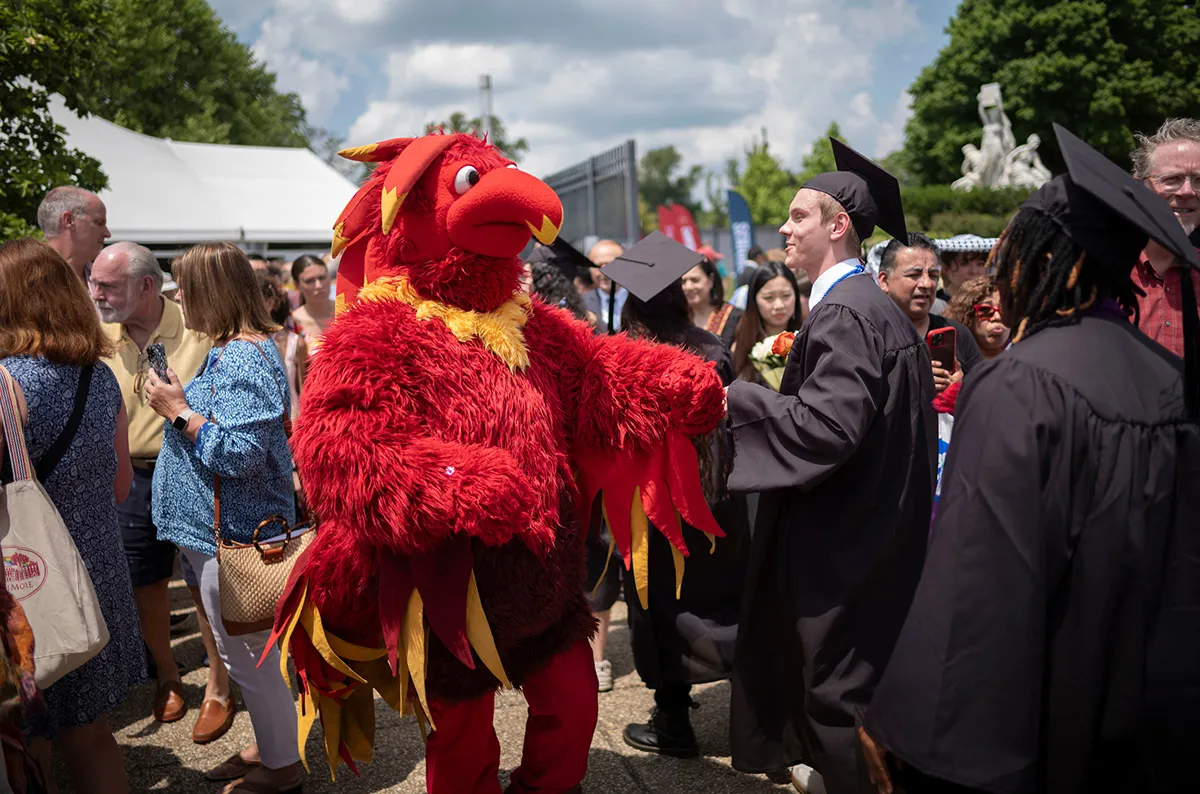 Phineas celebrates with members of graduating class