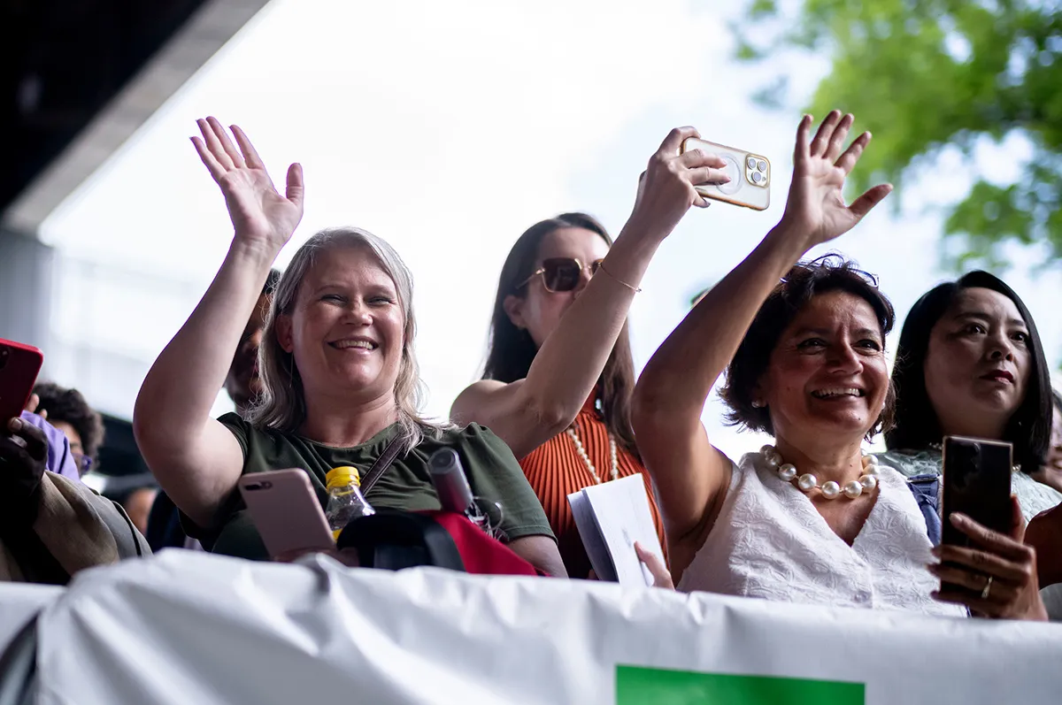 Parents wave to graduating seniors