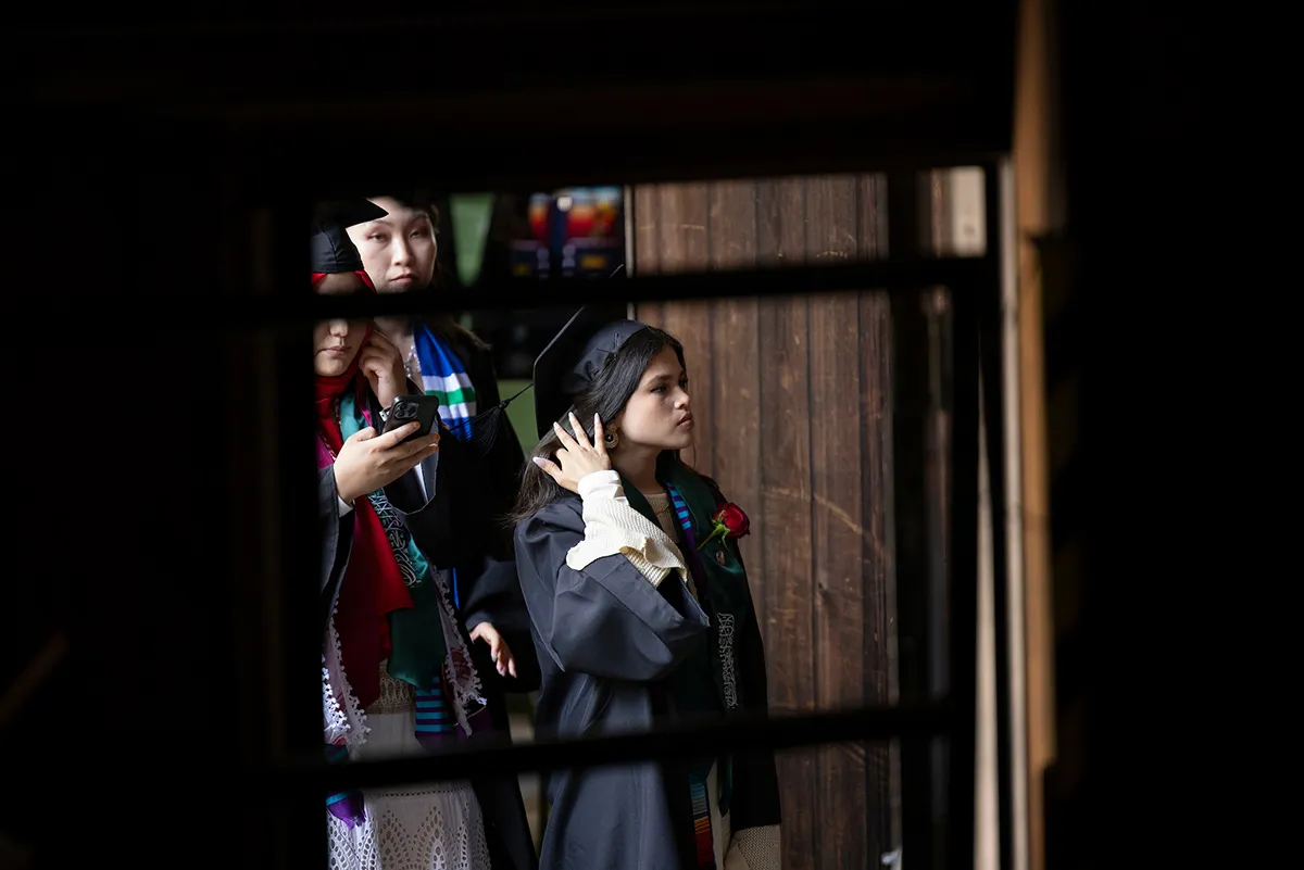 Student awaits turn to walk on stage during commencement ceremony