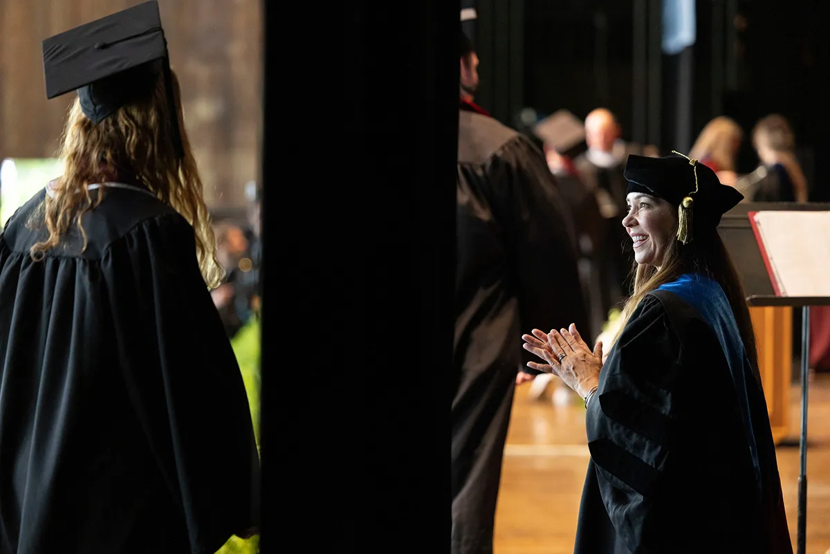 Student waits behind curtain before walking on stage