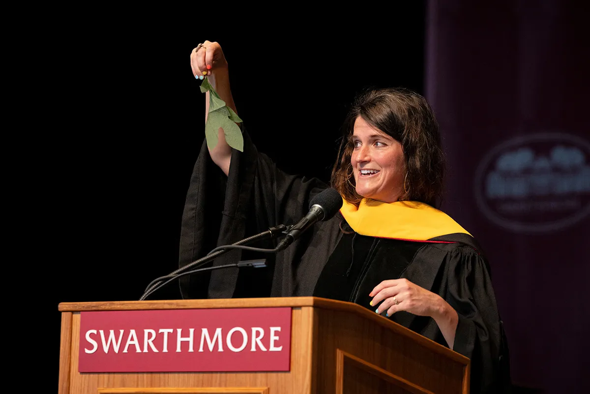 Lulu Miller '05 holds up leaf from sassafras tree