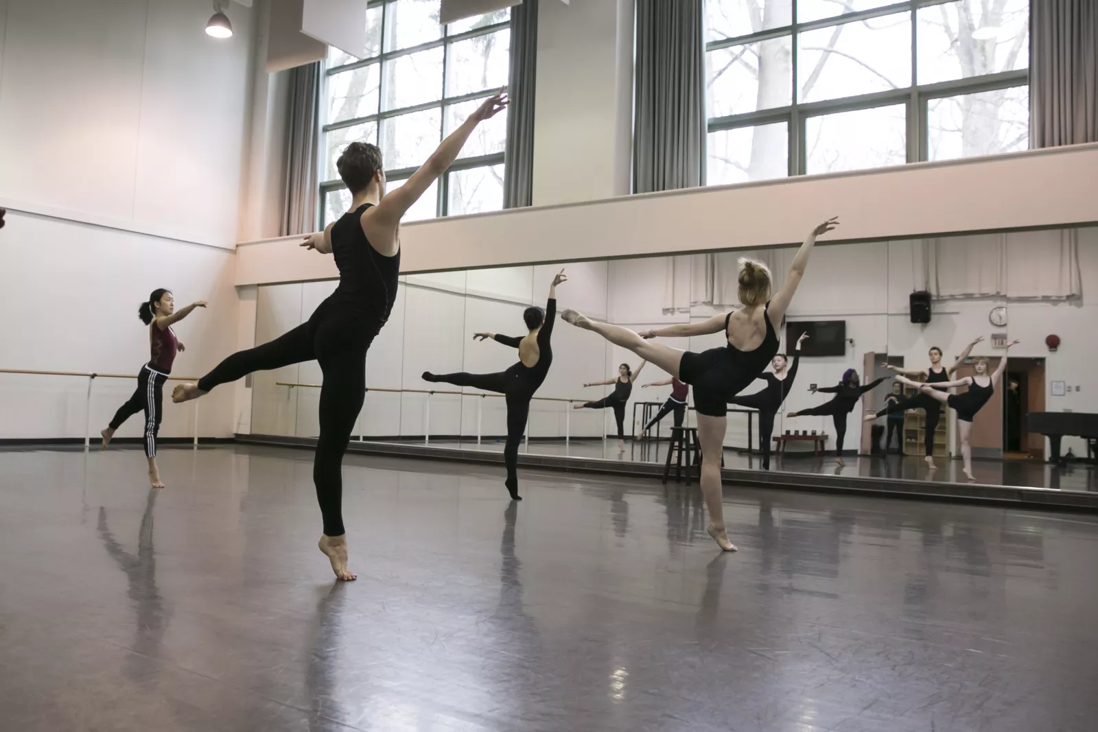 Dancers in rehearsal doing a pose. 