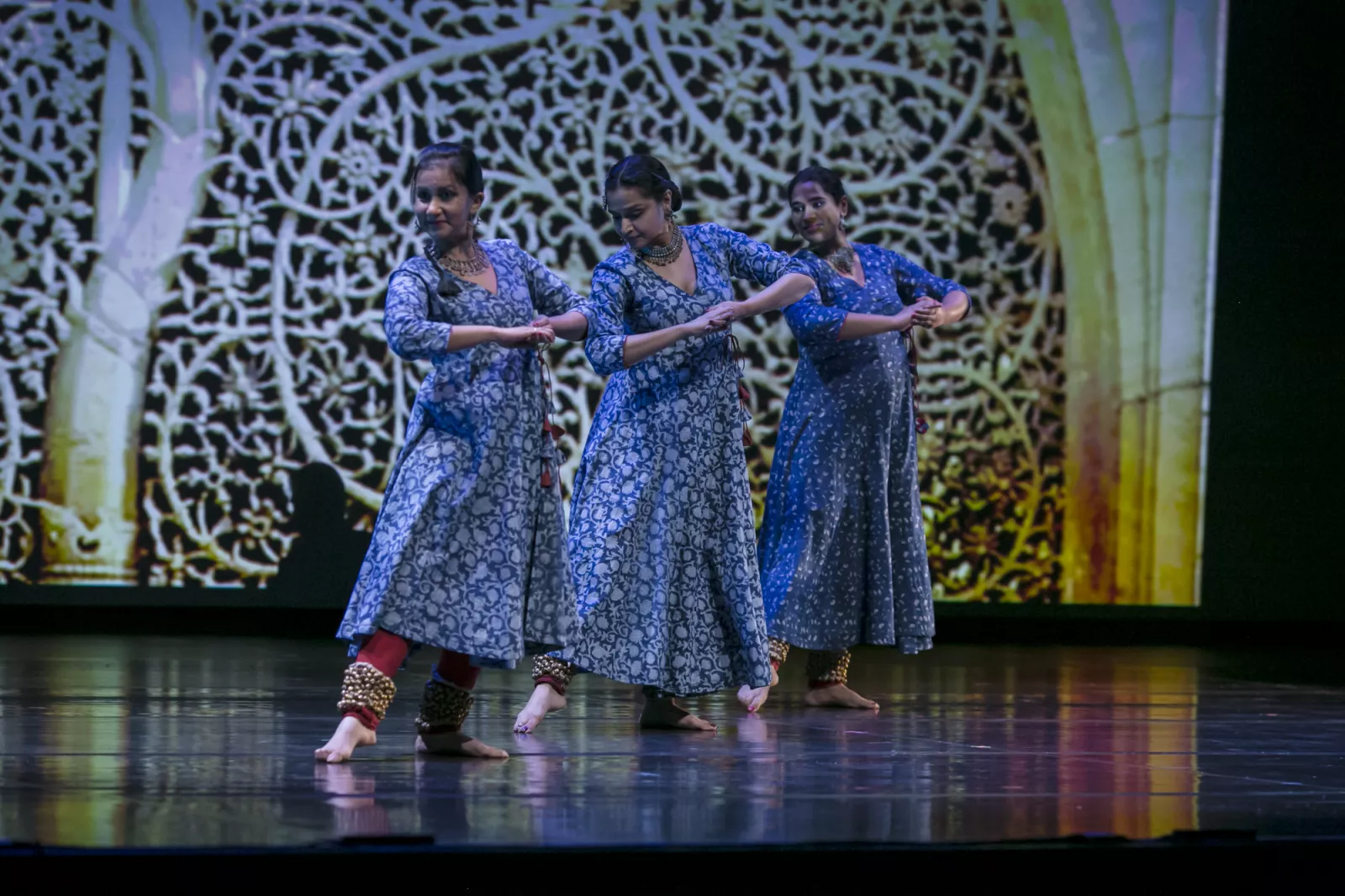 Kathak dancers with projected video, blue costumes. 