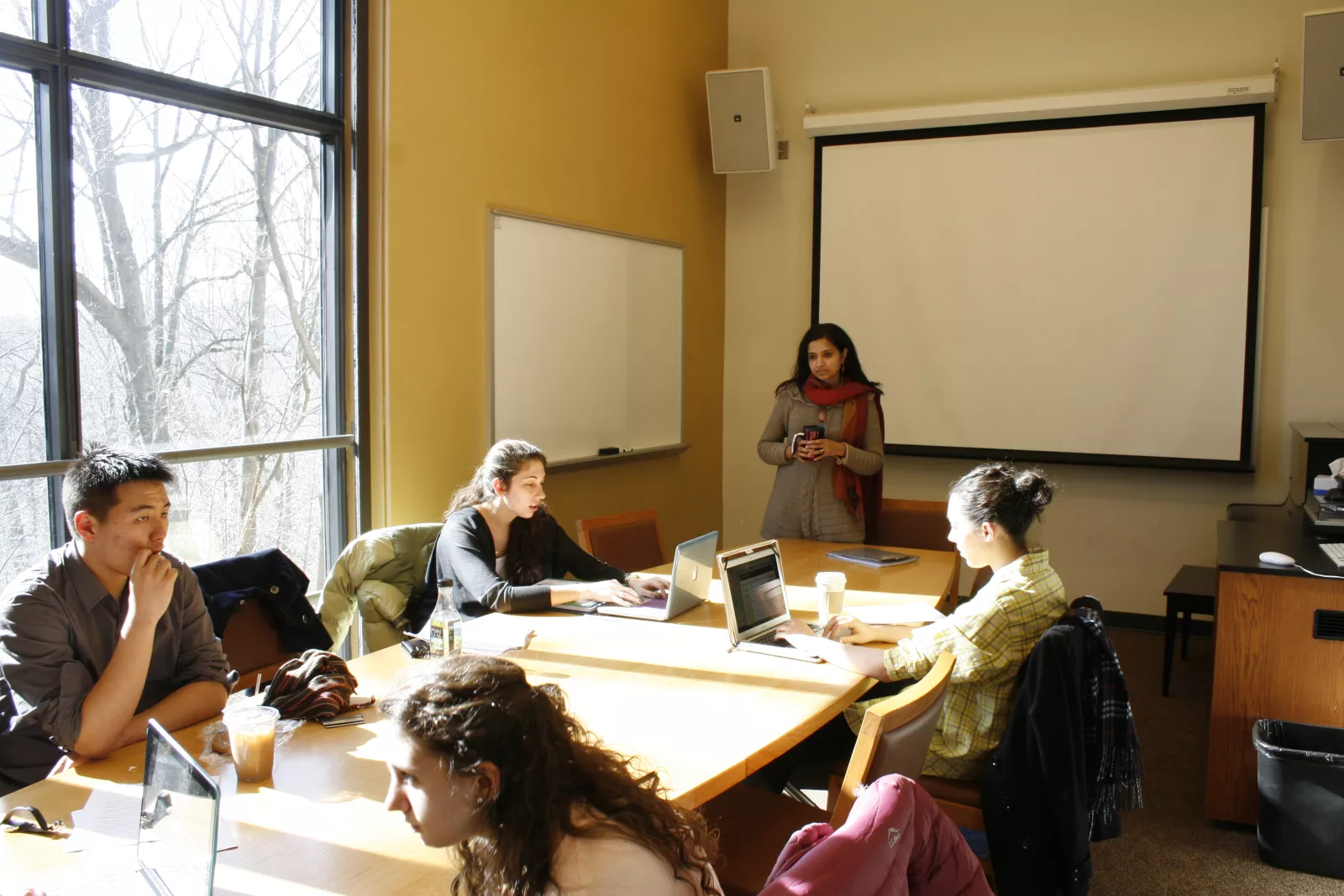 Dance academic class in front of a large window. 