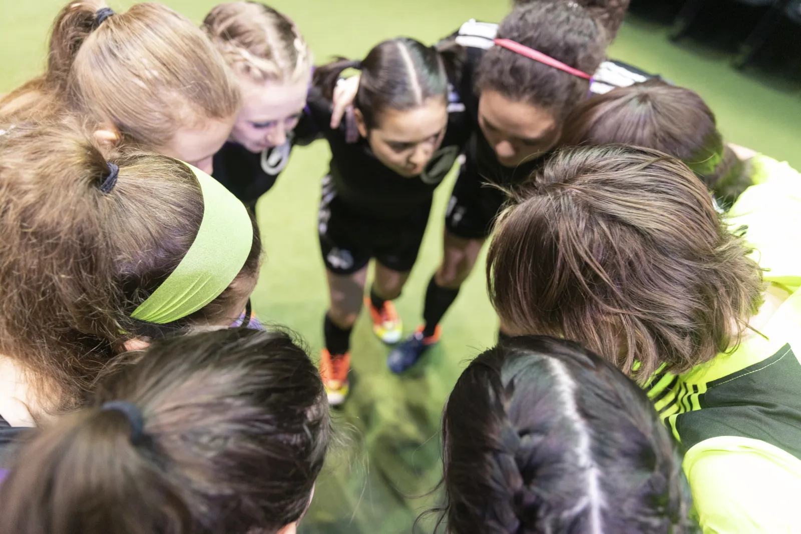 Players heads in a huddle 