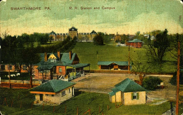 Colored postcard of the Swarthmore train station, looking up to Parrish Hall on the Swarthmore College campus