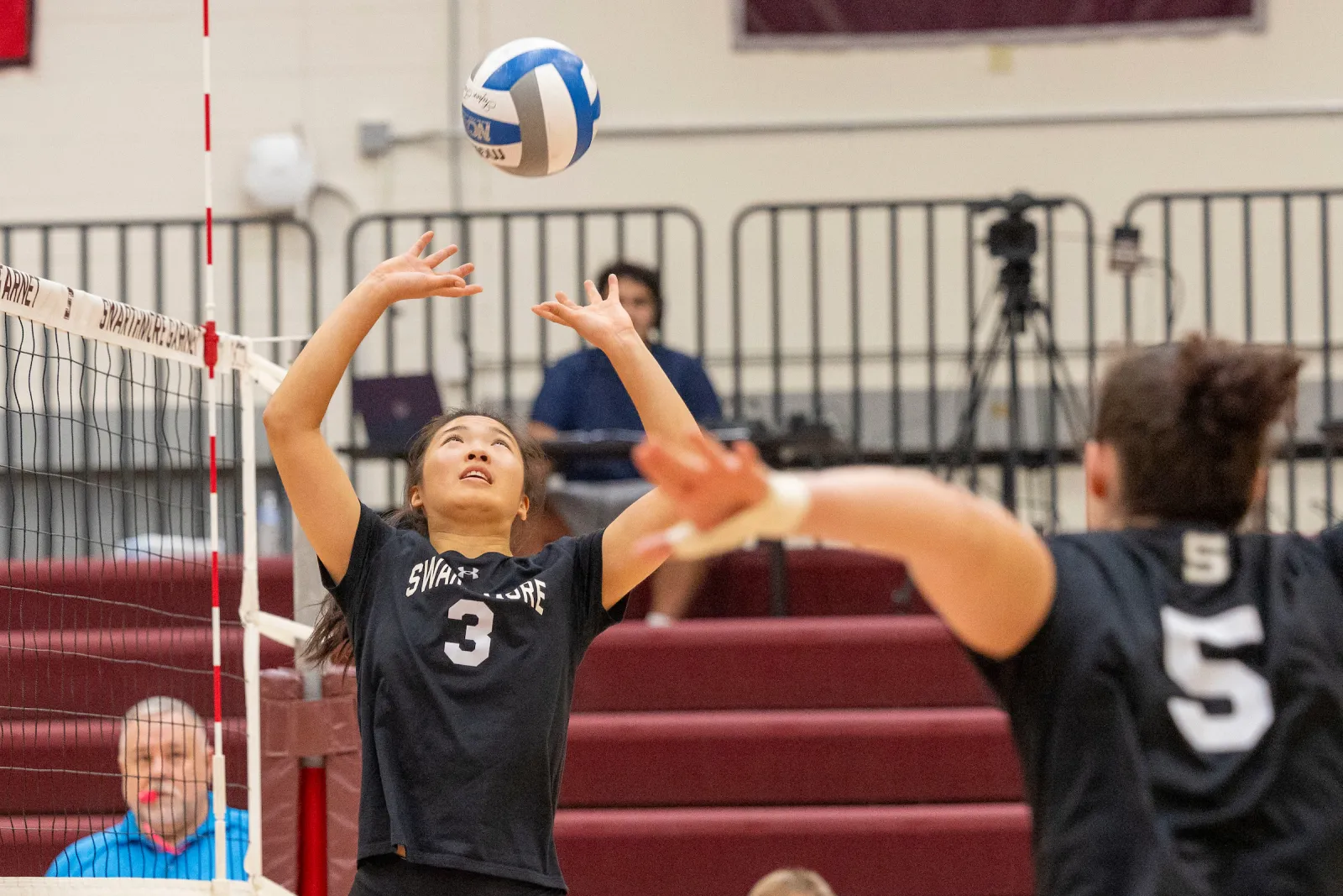 Swarthmore player sets volleyball during match