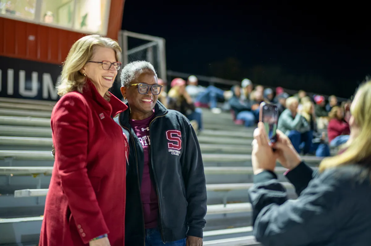 President Smith poses for photo at Swarthmore athletics game