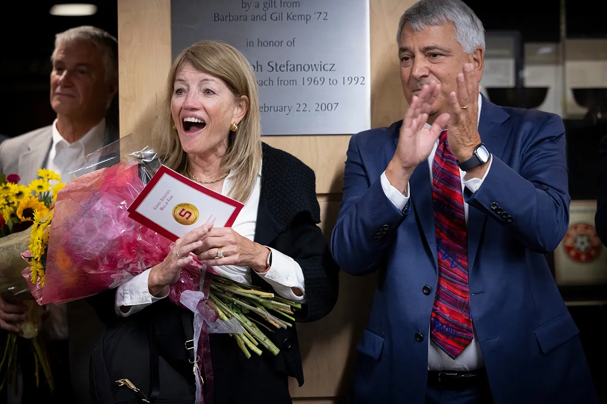 Person holding bouquet of flowers smiles in surprise