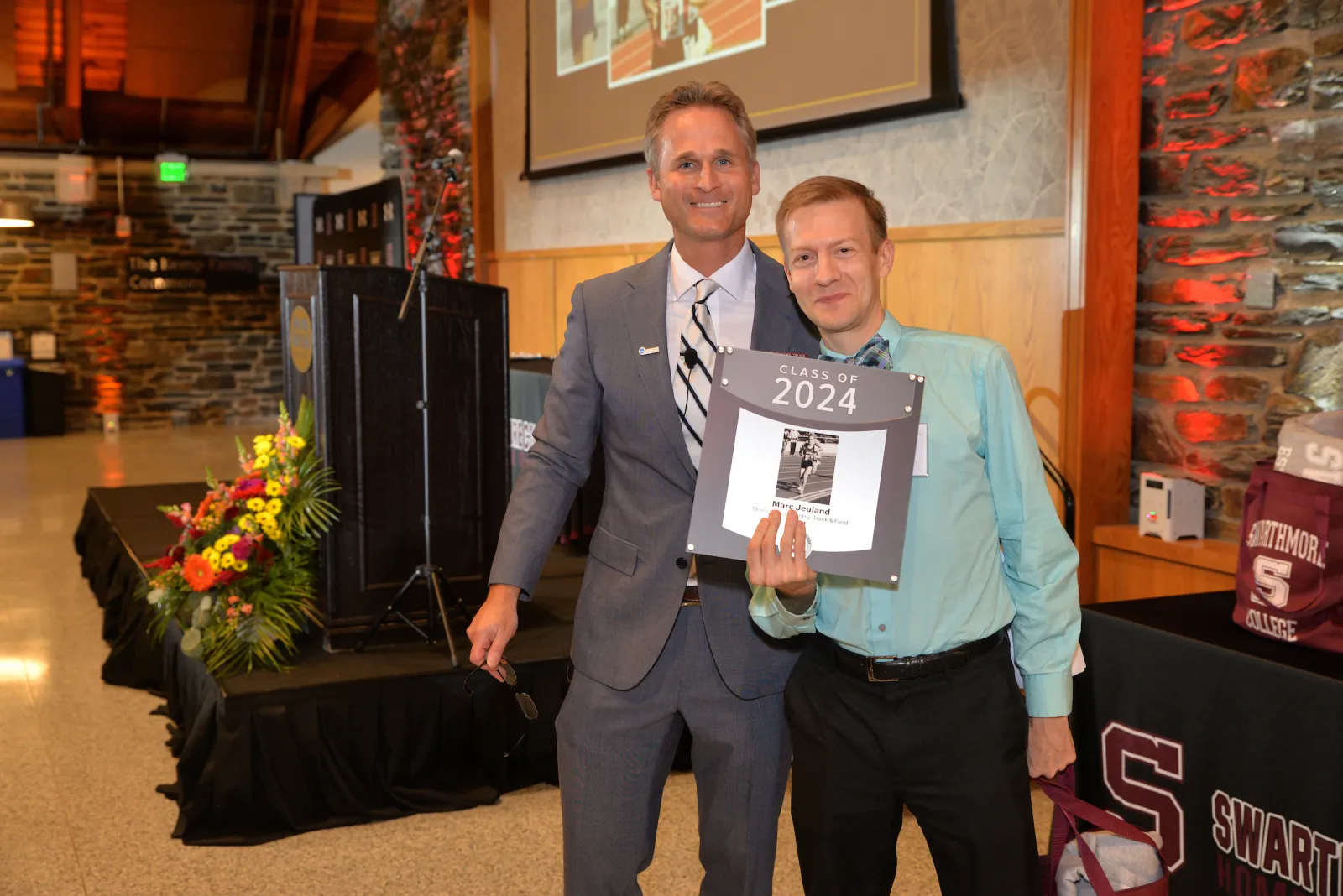 Marc Jeuland holds plaque with Brad Koch