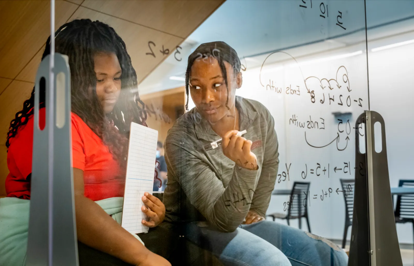 Dare 2 Soar tutor working with a student on a math problem.