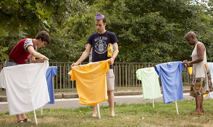 People hang t-shirts 