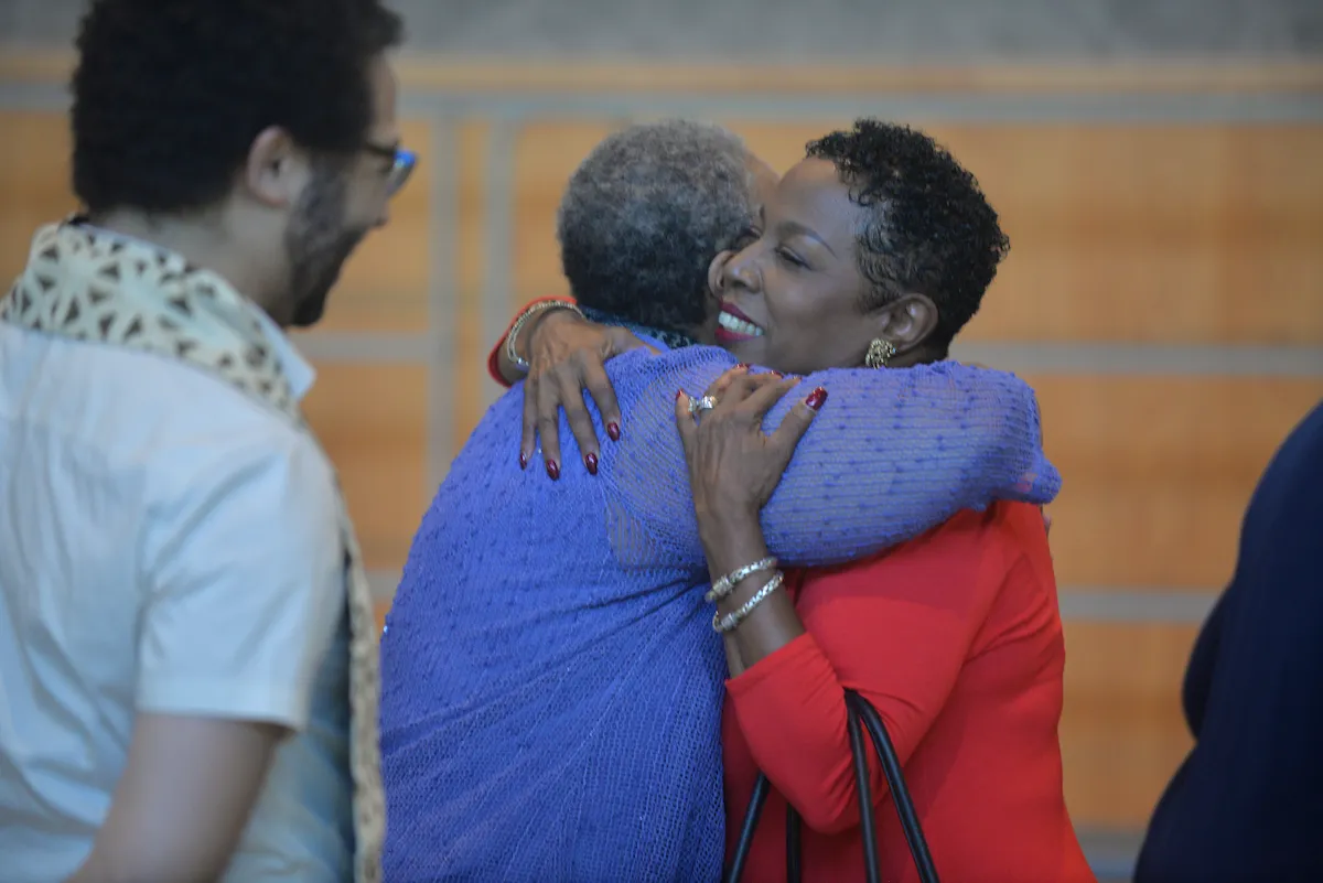 Gospel choir members reunite and hug