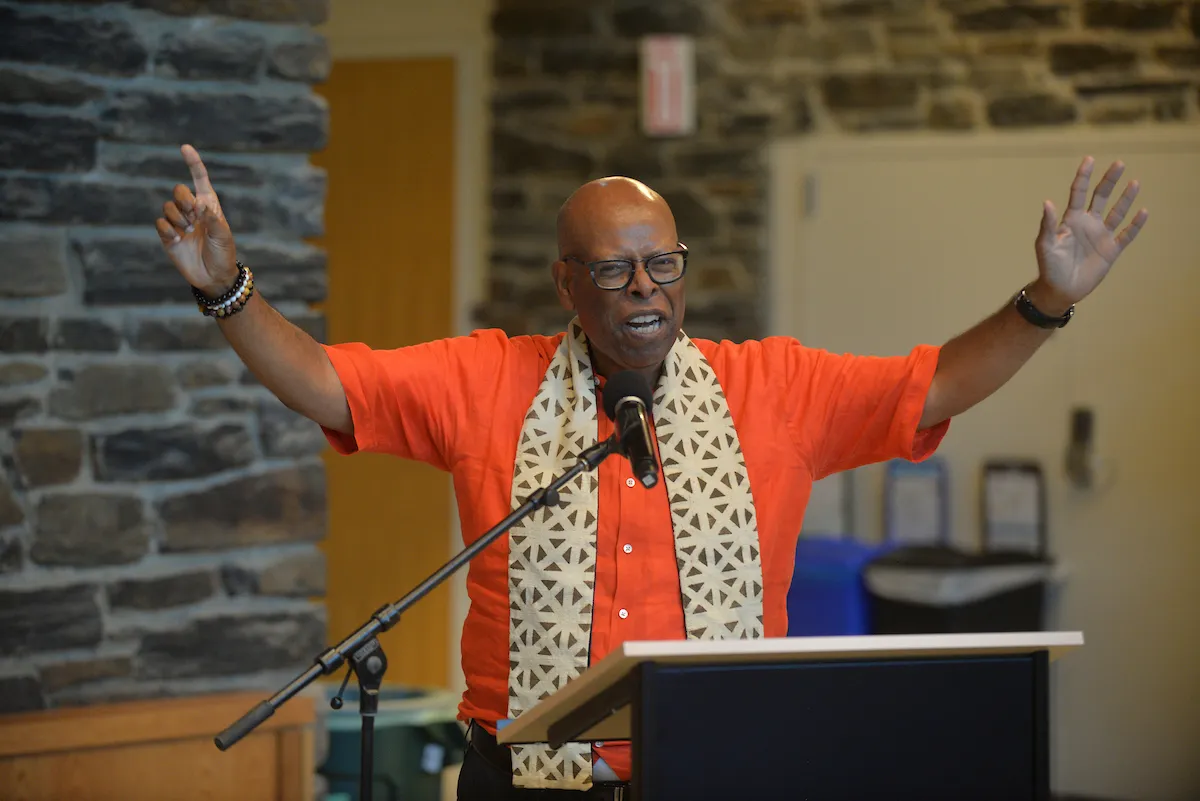 Gospel choir member speaks at podium