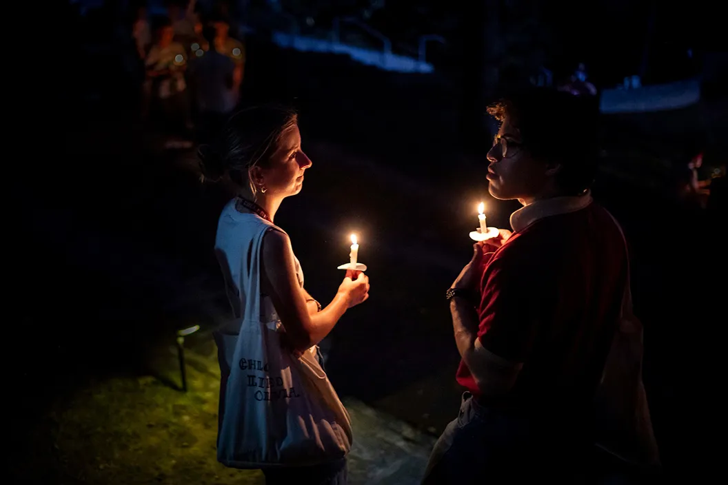 Students hold candles during Last Collection