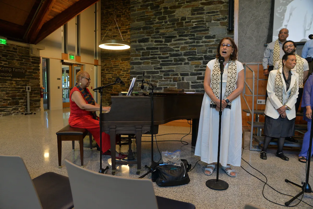 Gospel choir member performs with piano accompanying