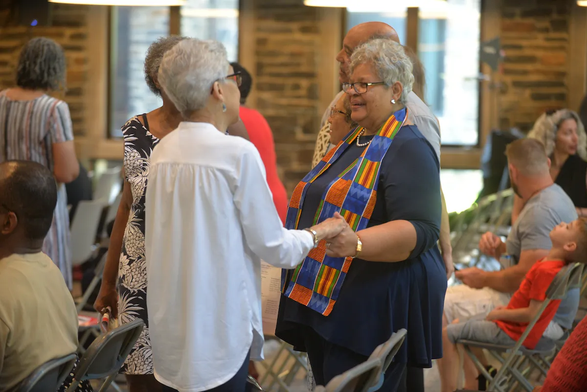 Gospel choir members reunite and hold hands