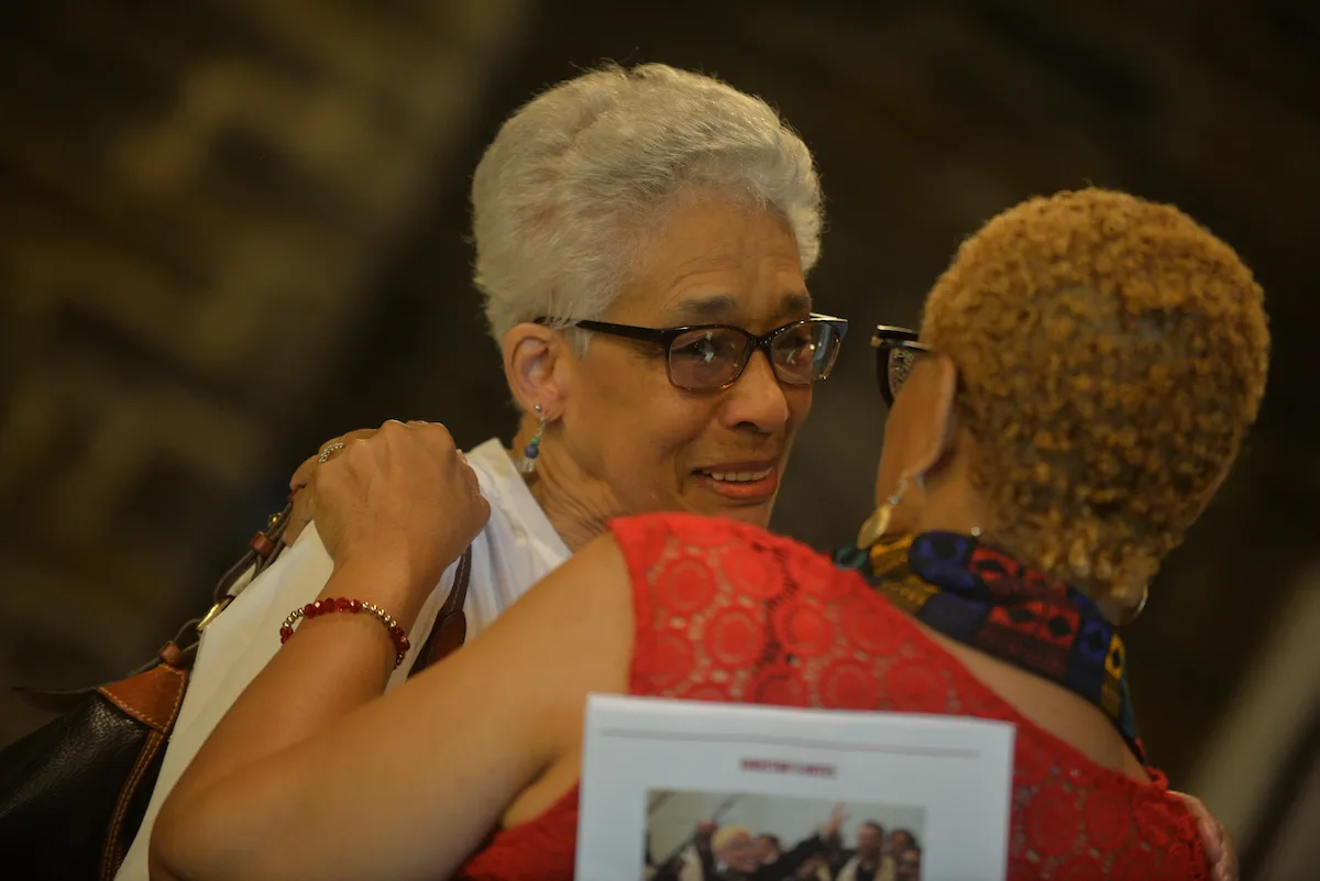 Gospel choir members hug after concert