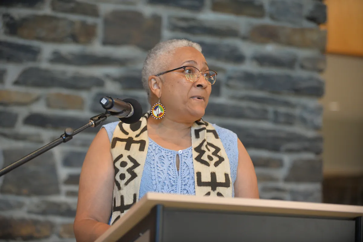 Gospel choir member speaks at podium