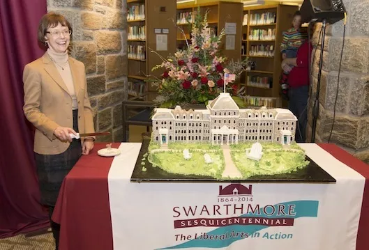 Rebecca Chopp cuts the cake