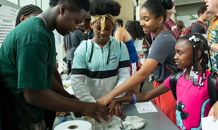 Children hold jar at science fair