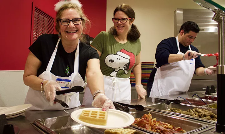 Staff serves breakfast during midnight breakfast