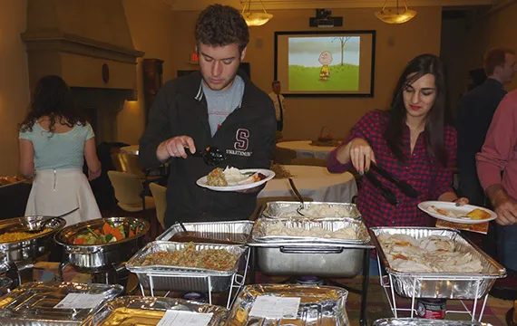 Staff and students at a Thanksgiving dinner