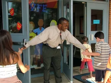 Principal welcomes students to school.