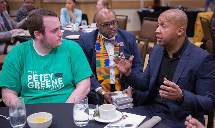 Stevenson talks to a student during a dinner