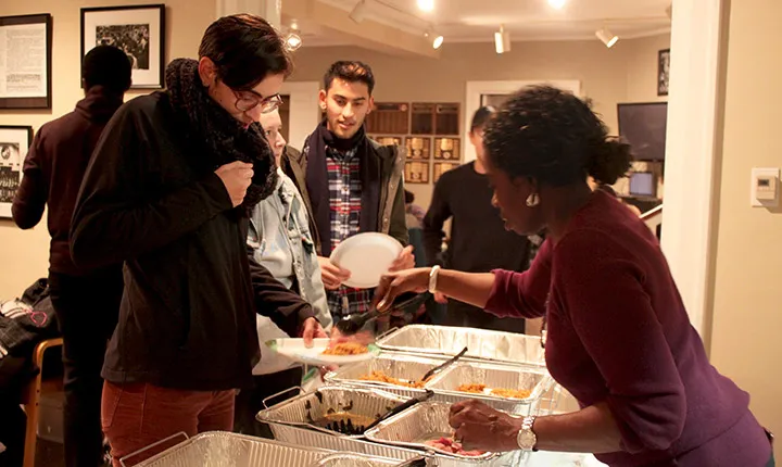 A student serves food during the BCC Thanksgiving dinner