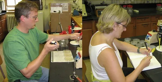 Two people working at a biology lab bench