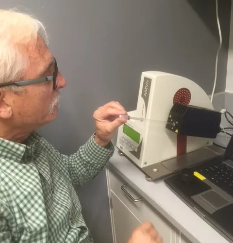 Bill Dean showing me how to use a viscometer to determine the exact viscosity of our buffer, which is an important parameter in fitting AUC data