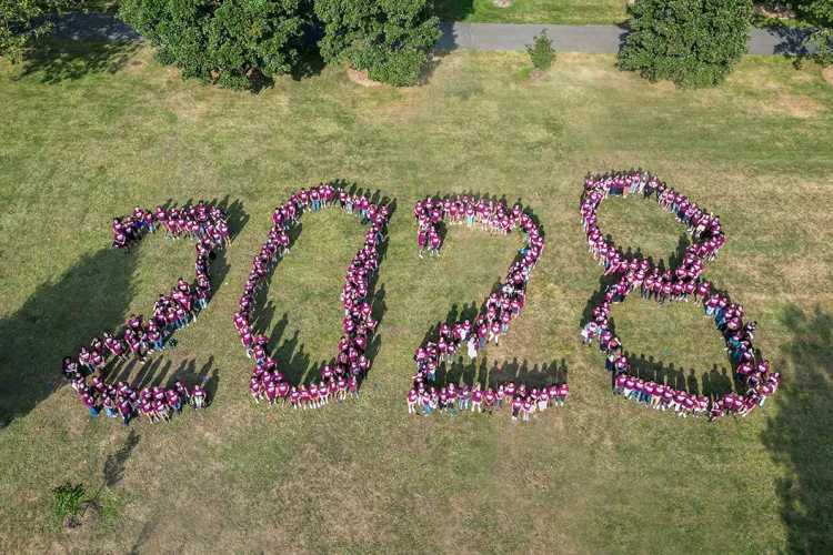 Class of 2028 members form giant "2028" on lawn