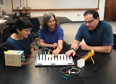 Senior Laboratory Lecturer Mary Ann Klassen (center) with Professor of Physics Catherine Crouch and Visiting Assistant Professor of Physics Benjamin Geller ‘01