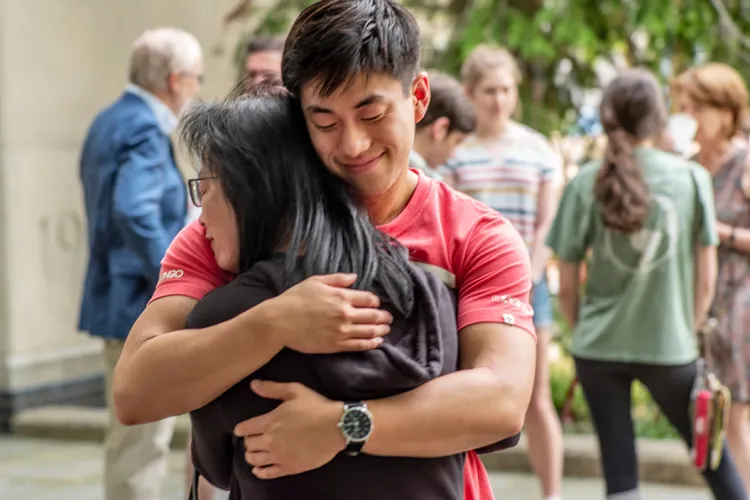 Student hugs family member 