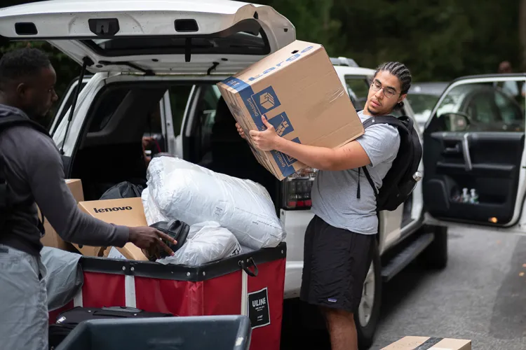 Student moves box from car