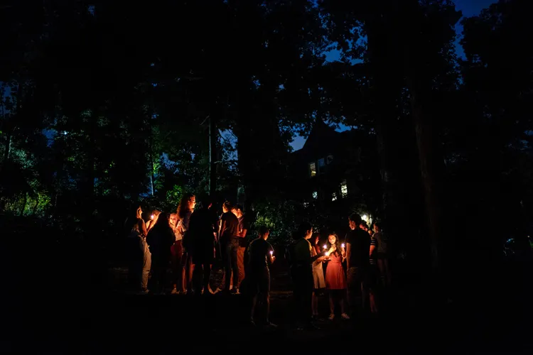 Students hold candles at first collection