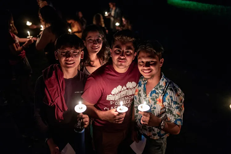 Students hold candles at first collection