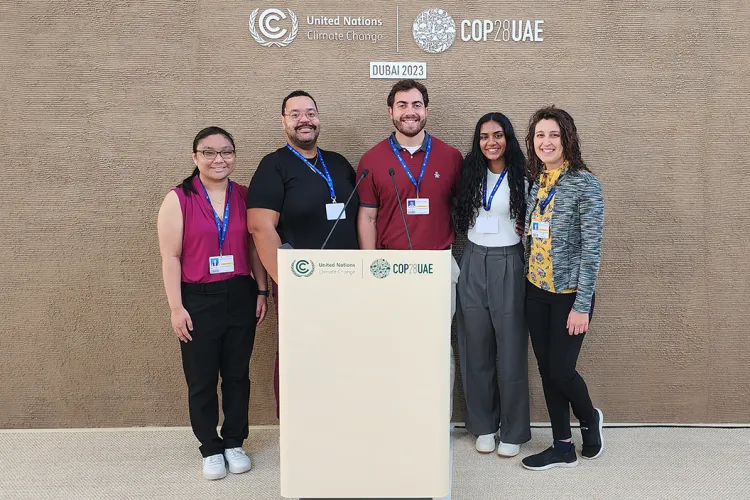 Swarthmore contingent at podium of COP28